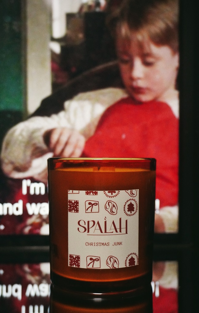 Red candle 'Apple Pie' with a slice of apple pie resting on top of the container