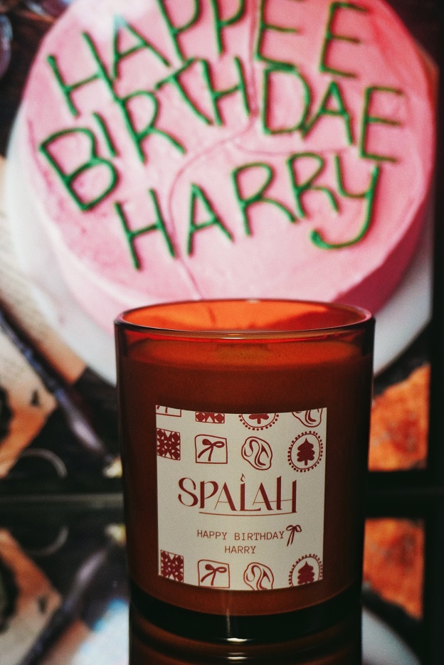 Red candle 'Apple Pie' with a slice of apple pie resting on top of the container