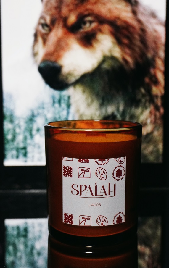 Red candle 'Apple Pie' with a slice of apple pie resting on top of the container