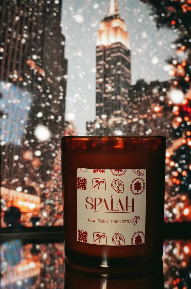 Red candle 'Apple Pie' with a slice of apple pie resting on top of the container