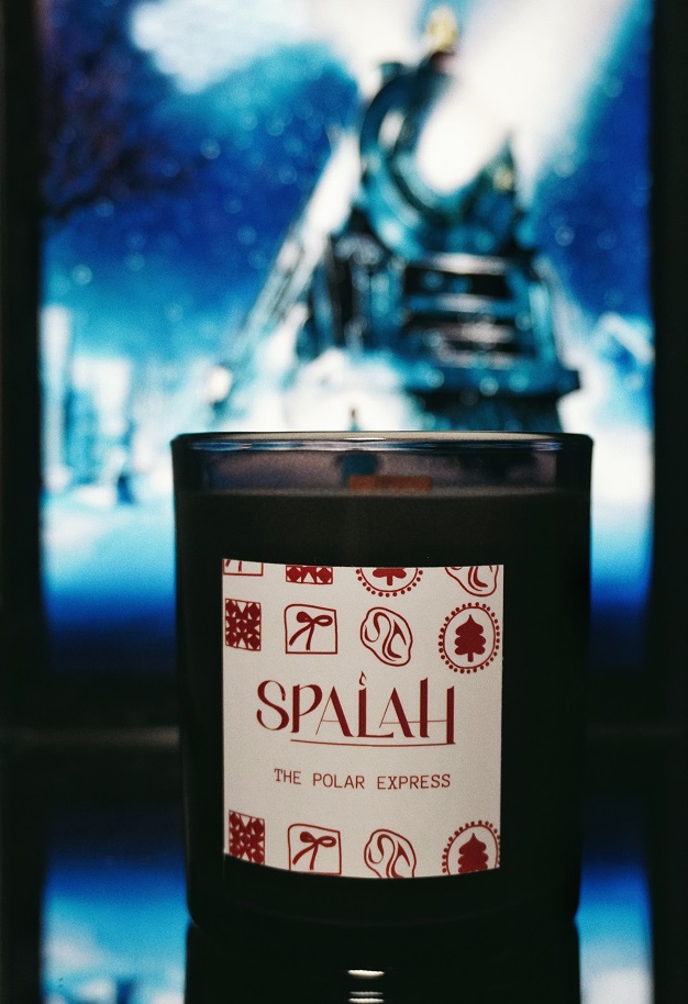 Red candle 'Apple Pie' with a slice of apple pie resting on top of the container