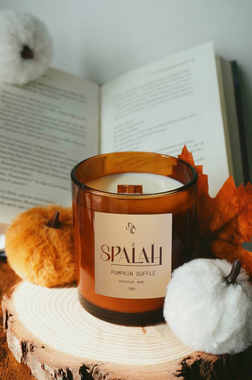 Red candle 'Pumpkin Suffle' with a slice of pumpkin suoffle resting on top of the container