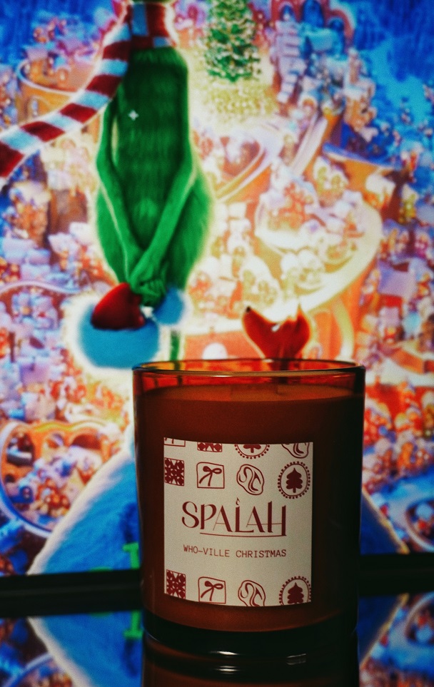 Red candle 'Apple Pie' with a slice of apple pie resting on top of the container